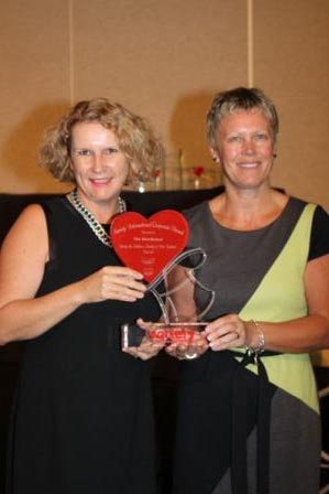 L-R - Lorraine Taylor, Variety CEO presents award to Kim Russell, Fundraising Manager of The Warehouse